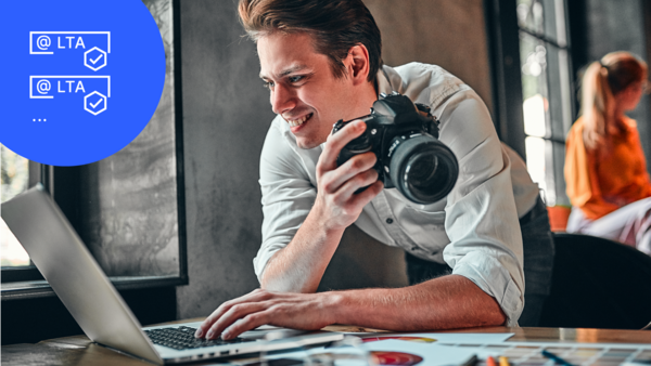 Man with camera looking at the laptop with LTA icon