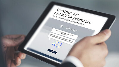 Tablet with website view of the digital assistant from LANCOM, held in two hands