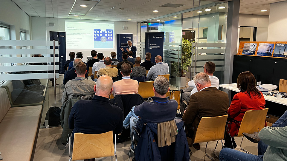 LANCOM event featuring a presentation on the NIS2 directive and network security solutions, delivered to an attentive audience.